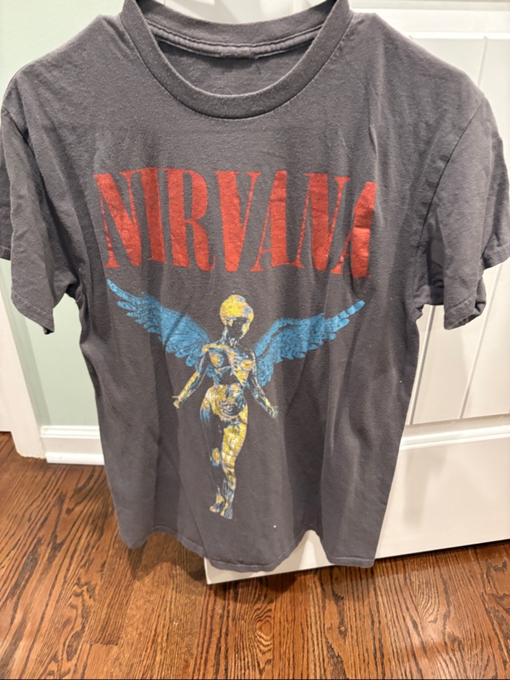 NIRVANA Black Tee with Red Logo and Blue & Yellow Angel Graphic
